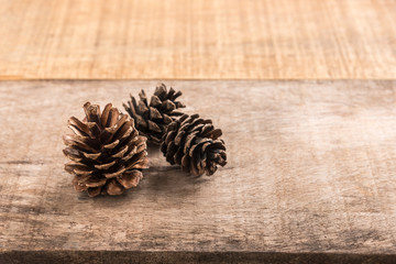 Obraz na płótnie Canvas Pine cones on wooden background