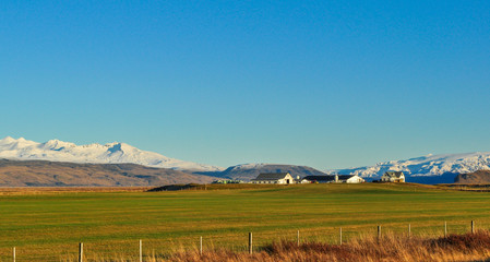 Landscape of a farm in the interior of Iceland with mountains in the background