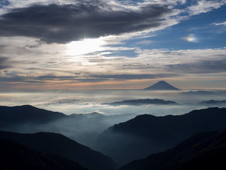 Mt. Fuji over the mist with the overcast sky after sunrise in the morning, captured from Kitadake,...