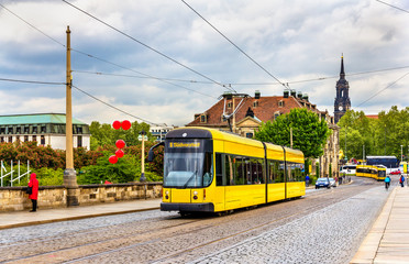 Fototapeta na wymiar City tram on Augustus bridge in Dresden