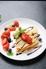 pancake with strawberry on white plate