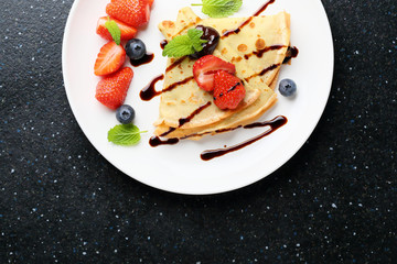 pancake with berries on white plate