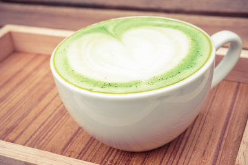 cup of green tea on the wood background