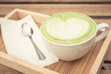 cup of green tea on the wood background