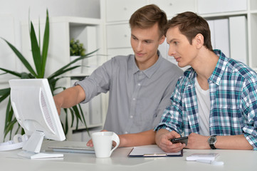 portrait of handsome men with computer 