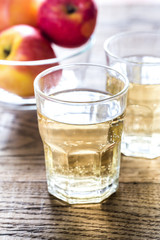 Two glasses of cider on the wooden background