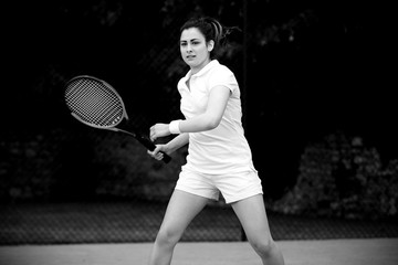 Fototapeta na wymiar Pretty tennis player playing on court