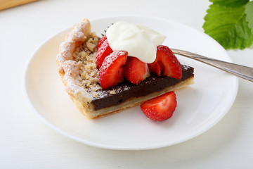 piece of strawberries and chocolate tart