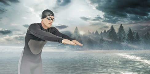 Composite image of swimmer in wetsuit while diving