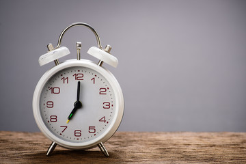 Retro white alarm clock with gray background