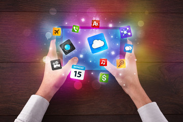 hands holding tablet