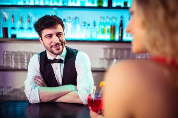 Bartender looking at woman in nightclub