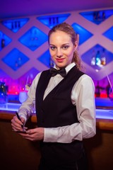 Confident young barmaid at counter