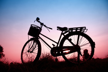 Fototapeta na wymiar beautiful landscape image with silhouette Bicycle at sunset