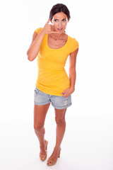 Smiling brunette gesturing a phone call