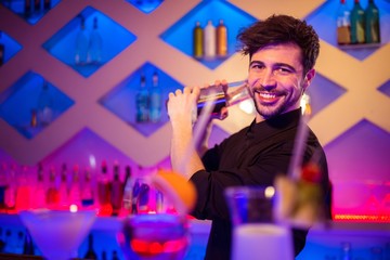 Handsome barkeeper preparing cocktail 