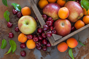 Organic fruit in a vintage wooden box on a rusty industrial table