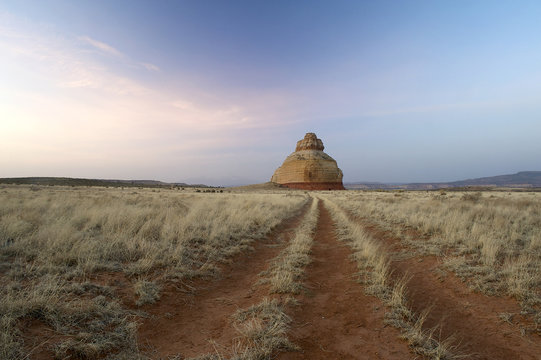 Rocky outcrop on flat grassy landscape, colorado