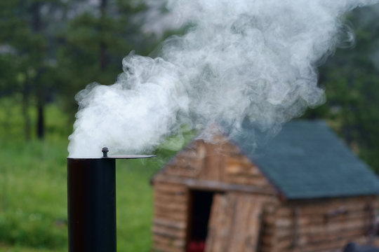 Smoke billowing from wood burners chimney