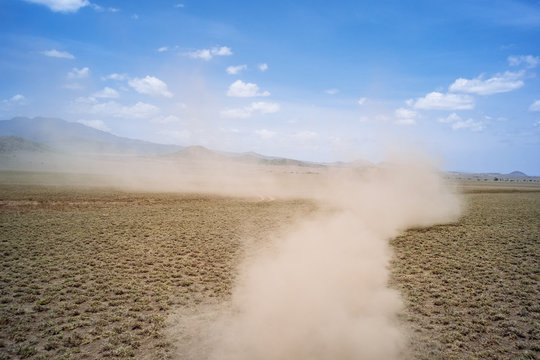 Dust Trail On Scrubland, Tanzania