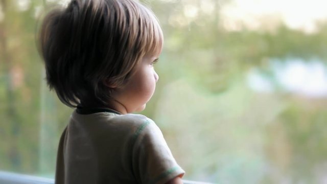 cute baby boy kid toddler child looking out the window