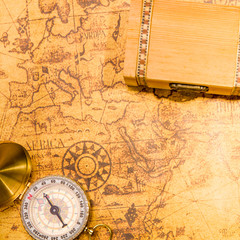 Vintage compass and maps with small treasure chase
