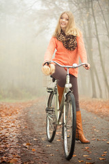 Obraz na płótnie Canvas Happy woman with bike bicycle in autumn park.