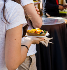 Woman holding a tasty potatoe dish.