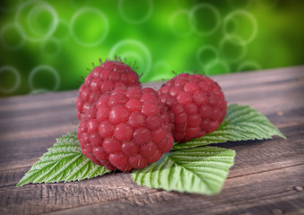 Raspberries with leaves on wooden desk. 3D render