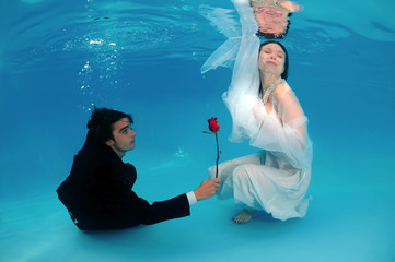 Bride and groom, underwater wedding in a pool