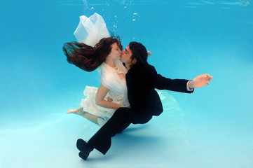 Bride and groom, underwater wedding in a pool