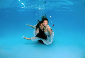 Bride and groom, underwater wedding in a pool