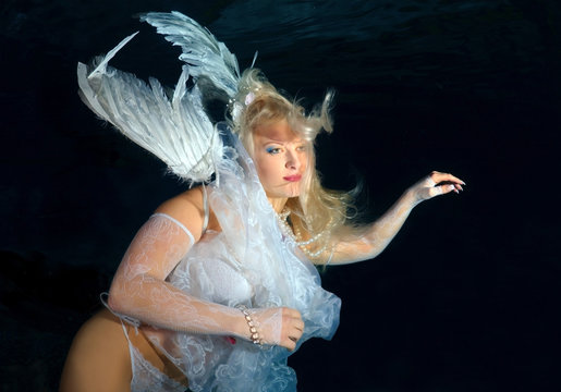 Underwater model presenting fashion in pool