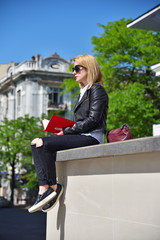 girl sitting on roof with book