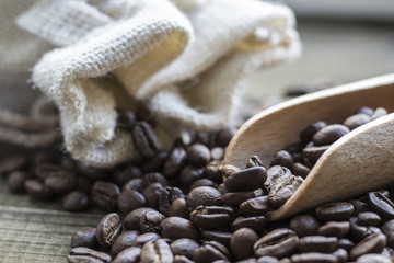 Coffee beans with wooden scoop and linen bag 