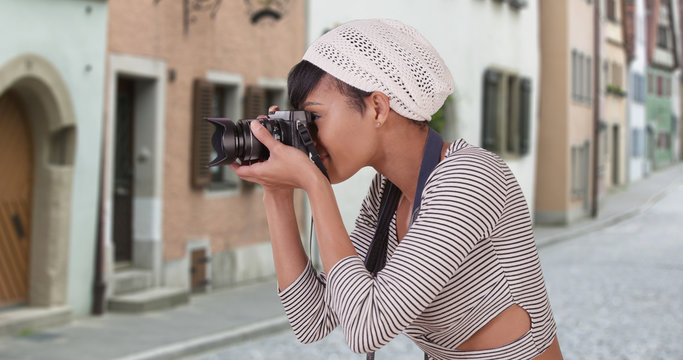 Woman with camera taking photo on Venice Italy city street