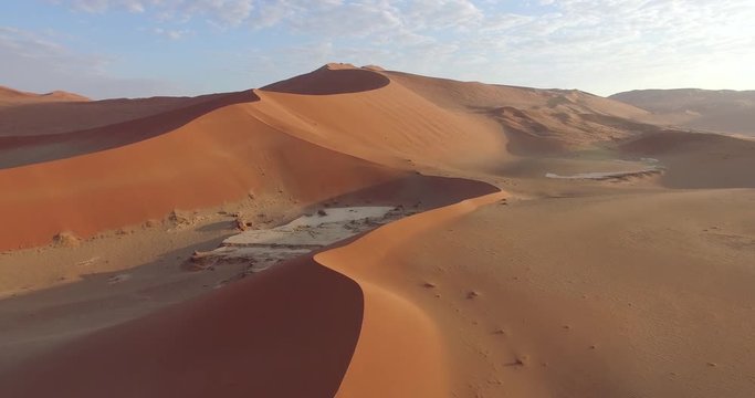 4K aerial view of endless sand dunes of the Namib desert inside the Namib-Naukluft National Park 
