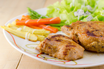 Grilled steaks on dish with salad