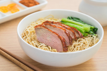 Roasted duck with noodles in bowl