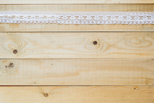 crafts concept, lace ribbon on wooden background