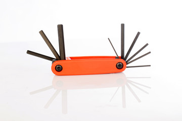 Hand holding screwdriver on white background, selective focus