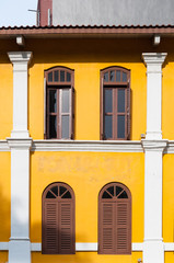 Old yellow building and brown windows