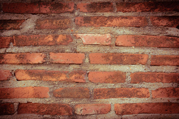 Weathered texture of stained old dark brown and red brick wall b