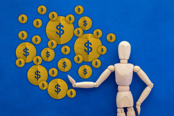 wood man figure presenting gold money coin