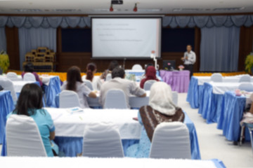 blur blurred abstract at Business education training conference hall or room seminar meeting People Analyzing Statistics Financial Concept  with attendee background