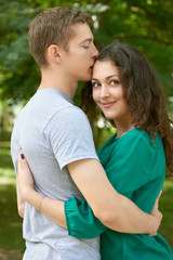 Obraz premium Romantic couple posing in city park, summer season, young people backside
