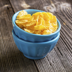 Healthy breakfast. Blue portioned ceramic bowls with corn flakes