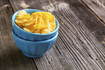 Healthy breakfast. Blue portioned ceramic bowls with corn flakes