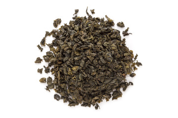 Organic Green Tea (Camellia sinensis) dried long leaves isolated on white background. Macro close up. Top view.