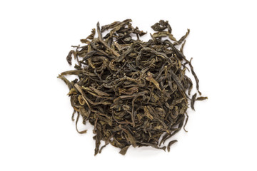 Organic Green Tea (Camellia sinensis) dried long leaves isolated on white background. Macro close up. Top view.